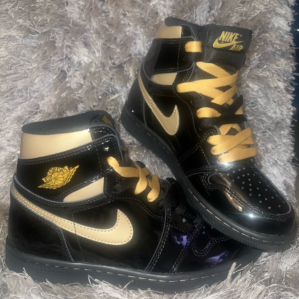 Black and gold Jordan 1s